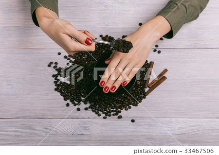 Woman applies coffee scrub on hands Woman applies coffee scrub on hands 33467506