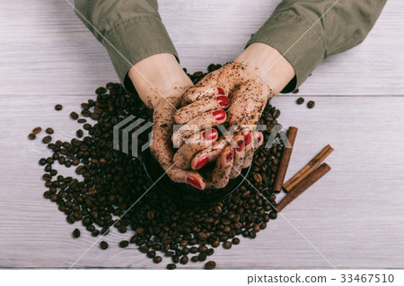 Female hands with red manicure with applied scrub Female hands with red manicure with applied scrub 33467510