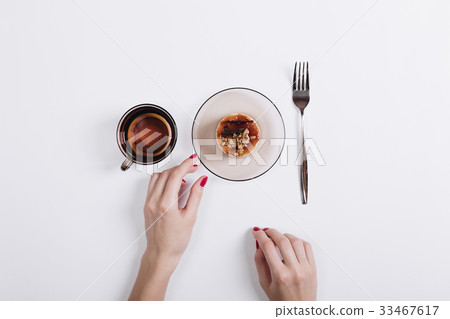 Female hand with red manicure takes the cake Female hand with red manicure takes the cake 33467617