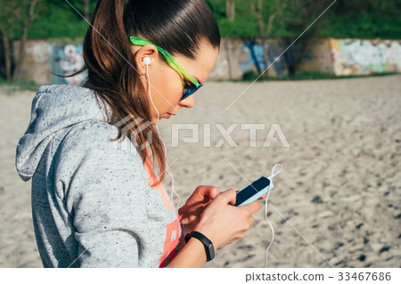 Young woman in sportswear with a hood Young woman in sportswear with a hood 33467686