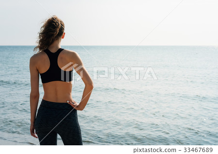 Sporty girl with curly hair in a sports bra 33467689