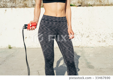 Cropped image of sports girl with a skipping rope Cropped image of sports girl with a skipping rope 33467690