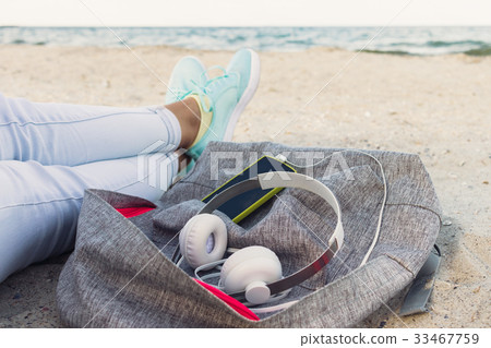 Women's legs in jeans and sneakers, backpack Women's legs in jeans and sneakers, backpack 33467759