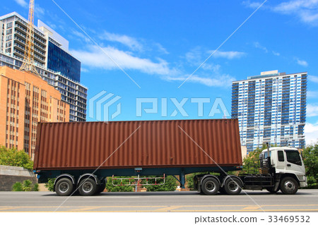 Delivery truck drives through a city in the day 33469532