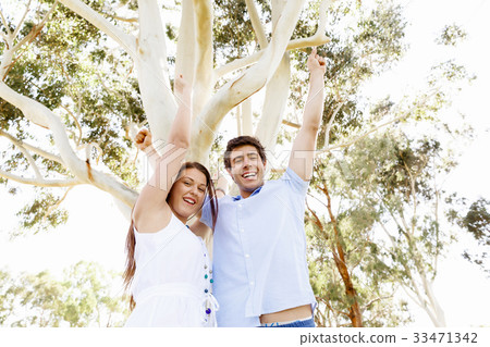 Young couple in the park celebrating 33471342