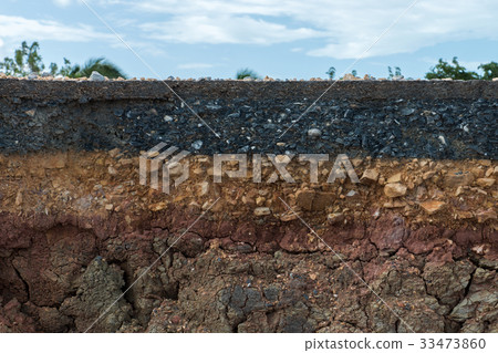 The layer of asphalt with soil and rock. 33473860