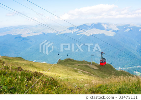 A view to red open cableway cabin over the top of A view to red open cableway cabin over the top of 33475111