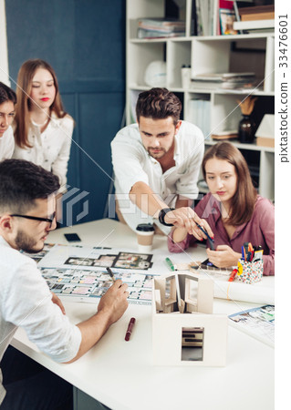 Confident team of engineers working together in a architect studio. Confident team of engineers working together in a architect studio. 33476601