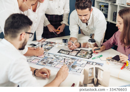 Team of architects working on construction plans Team of architects working on construction plans 33476603