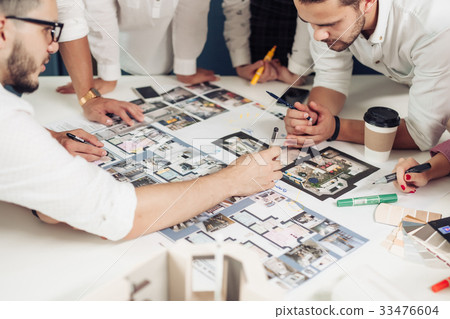 Team of architects working on construction plans Team of architects working on construction plans 33476604