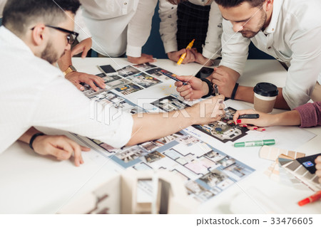 Team of architects working on construction plans 33476605