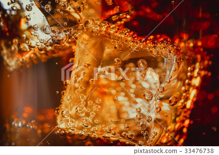Beautiful cola with ice cubes close up in glass Beautiful cola with ice cubes close up in glass 33476738