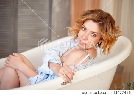 Beautiful young woman with long red curly hair Beautiful young woman with long red curly hair 33477436