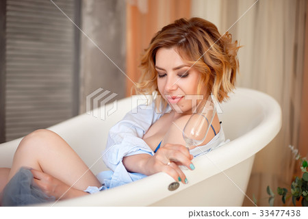 Beautiful young woman with long red curly hair Beautiful young woman with long red curly hair 33477438