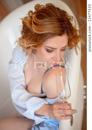 Beautiful young woman with long red curly hair Beautiful young woman with long red curly hair 33477439