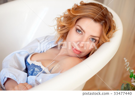 Beautiful young woman with long red curly hair Beautiful young woman with long red curly hair 33477440