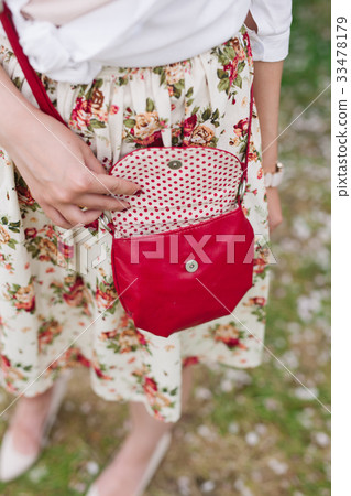 Closeup red bag in hands of woman on the street Closeup red bag in hands of woman on the street 33478179