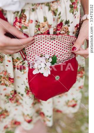 Closeup red bag in hands of woman on the street Closeup red bag in hands of woman on the street 33478182