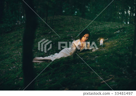 Portrait of a beautiful woman in the forest Portrait of a beautiful woman in the forest 33481497