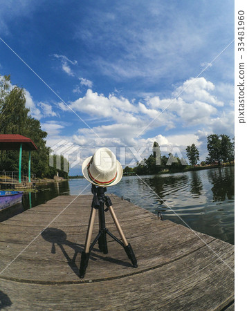 Tripod covered with a hat on the Wooden surface  33481960