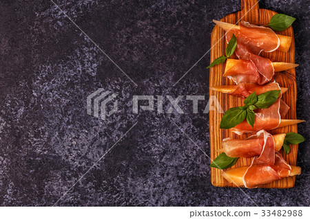 Fresh melon with prosciutto and basil. Fresh melon with prosciutto and basil. 33482988