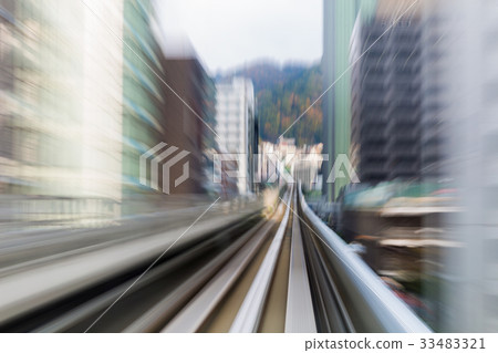 Blurred motion moving train to city downtown 33483321