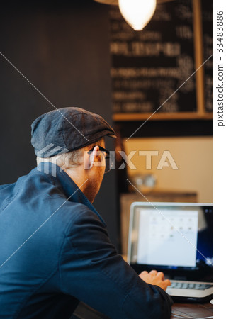 young businessman working on his laptop in a cafe young businessman working on his laptop in a cafe 33483886