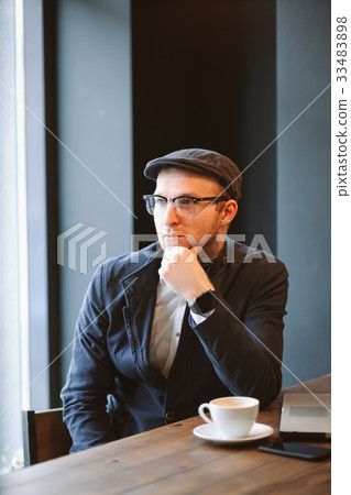 Tourist man in coffee shop glasses drinking coffee 33483898