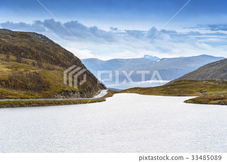 Asphalt curved road along mountain, Tromso, Norway Asphalt curved road along mountain, Tromso, Norway 33485089