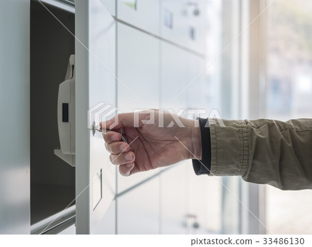 Hand with Key Open Locker in Locker room Hand with Key Open Locker in Locker room 33486130
