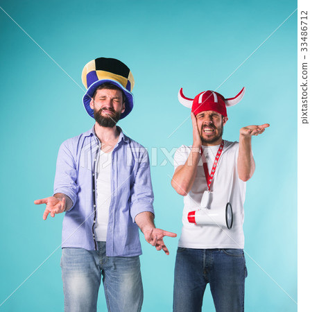 The two football fans over blue The two football fans over blue 33486712