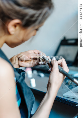 The girl is engaged in jewelry business The girl is engaged in jewelry business 33487413
