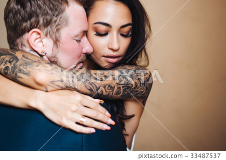 Beautiful, young couple posing on camera indoors 33487537