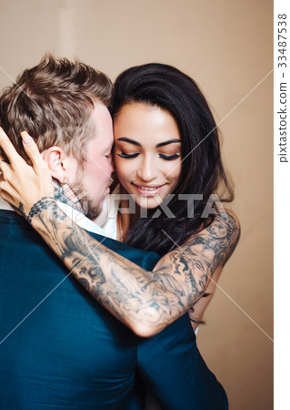 Beautiful, young couple posing on camera indoors 33487538