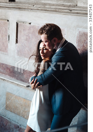 Beautiful, young couple posing on camera indoors 33487543