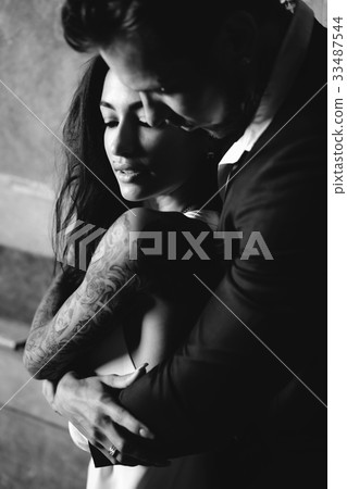 Beautiful, young couple posing on camera indoors 33487544