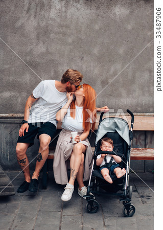 Mom, Dad and little son in a pram Mom, Dad and little son in a pram 33487906