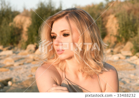 Portrait of a fashionable young woman at sunrise. Portrait of a fashionable young woman at sunrise. 33488232