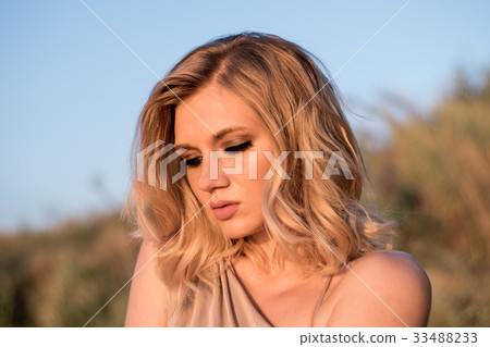 Portrait of a fashionable young woman at sunrise. Portrait of a fashionable young woman at sunrise. 33488233
