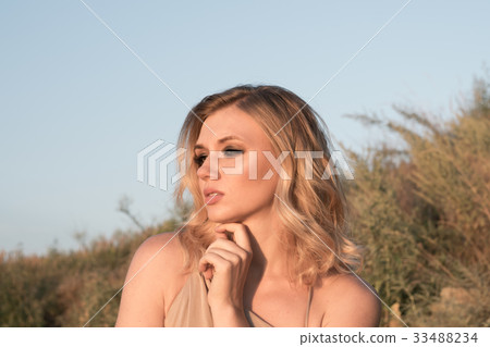 Blonde on nature background Blonde on nature background 33488234