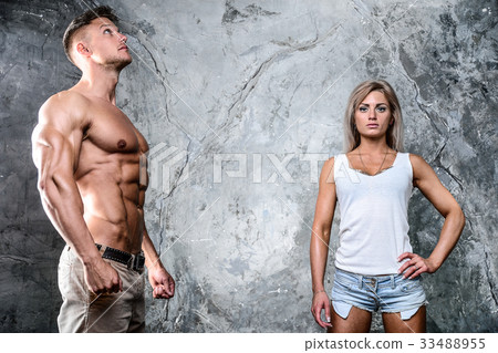 Beautiful young sporty sexy couple men and a woman posing Beautiful young sporty sexy couple men and a woman posing 33488955