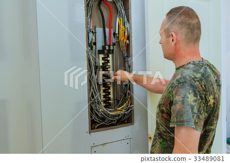 Professional electrician installing components  33489081