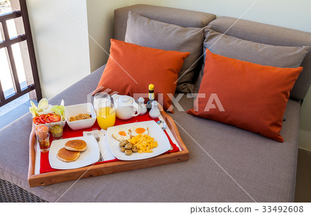 Breakfast in tray on bed 33492608