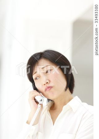 Woman talking on landline 33493380