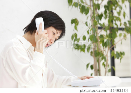 Woman talking on landline 33493384