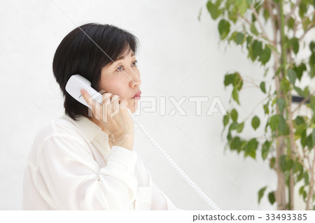Woman talking on landline 33493385