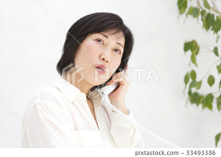 Woman talking on landline 33493386