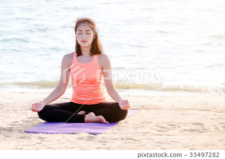 Asian woman close eyes and doing Hand Mudra yoga Asian woman close eyes and doing Hand Mudra yoga 33497282