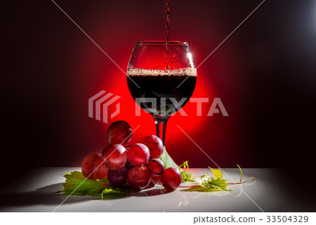pouring glass of red wine and grapevine with leaf pouring glass of red wine and grapevine with leaf 33504329