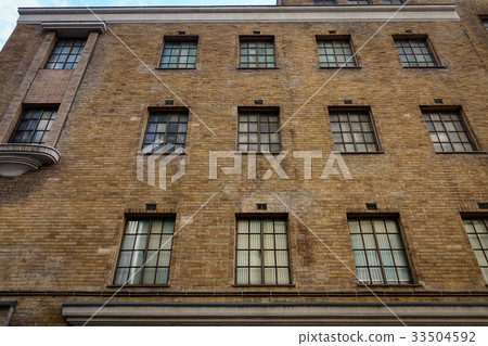 Old brick building with many windows 33504592